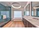 Modern bathroom featuring a standalone tub, a glass shower with teal tile, and floating vanity at 1900 Vero Dr, Las Vegas, NV 89134