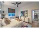 Stylish bedroom with modern art, an ensuite bathroom, and a sleek three-blade ceiling fan at 1900 Vero Dr, Las Vegas, NV 89134