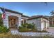 Inviting front porch with cozy seating, lush landscaping, and great architectural detail at 1900 Vero Dr, Las Vegas, NV 89134