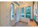 Bright foyer featuring a modern front door with sidelights and views of the landscaped yard at 1900 Vero Dr, Las Vegas, NV 89134