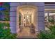 Inviting front porch with cozy seating and grand architectural columns framing the entrance at 1900 Vero Dr, Las Vegas, NV 89134
