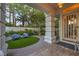Stylish front porch with outdoor seating, sleek columns, and views of landscaped yard at 1900 Vero Dr, Las Vegas, NV 89134