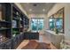Home office featuring built-in shelving, a large desk, and ample natural light at 1900 Vero Dr, Las Vegas, NV 89134