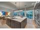 Bright kitchen with a large island, breakfast bar, and seamless flow to outdoor dining area at 1900 Vero Dr, Las Vegas, NV 89134