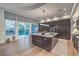 Spacious kitchen with an island, dark cabinets, and access to the backyard at 1900 Vero Dr, Las Vegas, NV 89134