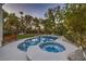 Inviting backyard pool and spa surrounded by lush landscaping, perfect for relaxation and outdoor enjoyment at 1900 Vero Dr, Las Vegas, NV 89134