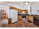Functional kitchen with oak cabinets, black appliances, and wood flooring at 2086 Angel Falls Dr, Henderson, NV 89074