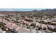 Wide aerial view of the residential area featuring diverse housing styles and breathtaking mountain backdrop at 2279 Pacini Ct, Henderson, NV 89052