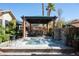 Inviting backyard oasis featuring a jacuzzi under a covered pergola with an outdoor bar at 2279 Pacini Ct, Henderson, NV 89052