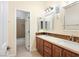 Spacious bathroom with double sinks, wood cabinets, and separate shower area at 2279 Pacini Ct, Henderson, NV 89052