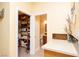 Bright bathroom featuring a walk-in closet and a well-lit sink area at 2279 Pacini Ct, Henderson, NV 89052