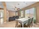 Open-concept dining room with stylish furniture, ceiling fan, and natural light, seamlessly connected to the living area at 2279 Pacini Ct, Henderson, NV 89052