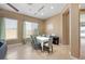 Bright dining room with large windows, modern lighting, neutral walls, and ceramic tile flooring at 2279 Pacini Ct, Henderson, NV 89052