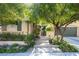 Charming home featuring mature landscaping and a welcoming entrance with gated courtyard and two car garage at 2279 Pacini Ct, Henderson, NV 89052