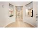 Inviting hallway with archways and ceramic tile floors, leading to the home's various rooms and living spaces at 2279 Pacini Ct, Henderson, NV 89052