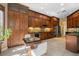 Chef's kitchen with ample storage, modern appliances, tile backsplash, and an adjacent dining area at 2279 Pacini Ct, Henderson, NV 89052