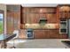 Well-equipped kitchen with stainless steel appliances, custom cabinets, and mosaic tile backsplash at 2279 Pacini Ct, Henderson, NV 89052