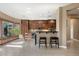 Open kitchen with breakfast bar, abundant natural light, plenty of storage, and tile floors, perfect for entertaining at 2279 Pacini Ct, Henderson, NV 89052