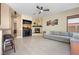 Open concept living area featuring a fireplace, tile floors, and comfortable seating at 2279 Pacini Ct, Henderson, NV 89052