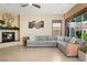 Spacious living room with fireplace, comfortable seating, and natural light at 2279 Pacini Ct, Henderson, NV 89052