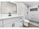 Updated bathroom with white marble style shower, white vanity and wood-look floors at 2729 Flower Ave, North Las Vegas, NV 89030