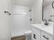 Bright bathroom with a shower-tub combination and a modern vanity with a sleek black faucet at 2729 Flower Ave, North Las Vegas, NV 89030