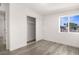 Bedroom featuring wood-look floors, a closet with sliding doors, and a window with blinds at 2729 Flower Ave, North Las Vegas, NV 89030