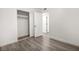 Bedroom with wood-look flooring, a closet with sliding doors, and a view into the hallway at 2729 Flower Ave, North Las Vegas, NV 89030