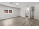 Bedroom with wood-look floors and a window providing natural light and access to an ensuite bathroom at 2729 Flower Ave, North Las Vegas, NV 89030