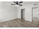 Bedroom showcasing wood-look floors, a sliding door closet, and a modern ceiling fan at 2729 Flower Ave, North Las Vegas, NV 89030