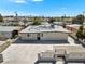 Charming single-story home featuring a secure gated yard, concrete driveway, and inviting front door at 2729 Flower Ave, North Las Vegas, NV 89030