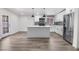 Bright, modern kitchen with center island, stainless steel appliances, and gray subway tile backsplash at 2729 Flower Ave, North Las Vegas, NV 89030