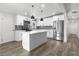 Modern kitchen with white cabinets, stainless steel appliances, subway tile backsplash, and quartz countertop island at 2729 Flower Ave, North Las Vegas, NV 89030