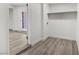 Functional laundry area with wood-look flooring, washer hookups, and convenient shelving for storage at 2729 Flower Ave, North Las Vegas, NV 89030