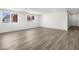 Bright and airy living room featuring wood-look flooring and ample natural light through large windows at 2729 Flower Ave, North Las Vegas, NV 89030