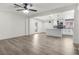 Open floorplan showcasing a living room flowing into a modern kitchen with white cabinetry and stainless appliances at 2729 Flower Ave, North Las Vegas, NV 89030