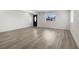 Spacious, bright living room with wood-look floors, a modern entryway, and plenty of space at 2729 Flower Ave, North Las Vegas, NV 89030
