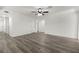 Bright living room featuring modern ceiling fan, fresh paint, and beautiful wood-look flooring at 2729 Flower Ave, North Las Vegas, NV 89030