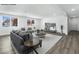 Bright, open living room with modern decor and wood-look floors offers a spacious design at 2729 Flower Ave, North Las Vegas, NV 89030