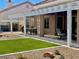 Backyard oasis with covered patio, artificial turf, and desert landscaping at 2736 Darby Falls Dr, Las Vegas, NV 89134