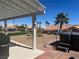 Relaxing backyard with hot tub, mature landscaping, and a covered patio, perfect for outdoor living at 2736 Darby Falls Dr, Las Vegas, NV 89134
