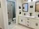 Bathroom featuring double sink vanity, walk-in shower and black fixtures at 2736 Darby Falls Dr, Las Vegas, NV 89134