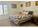 Bedroom with a colorful quilt, window with plantation shutters, and neutral carpet at 2736 Darby Falls Dr, Las Vegas, NV 89134