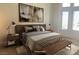 Staged bedroom with modern decor, a large bed, and neutral tones at 2736 Darby Falls Dr, Las Vegas, NV 89134