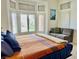 Cozy bedroom with seating area, a large bed, and plantation shutters at 2736 Darby Falls Dr, Las Vegas, NV 89134