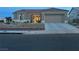 Single-story home featuring desert landscaping, a tile roof, and a two-car garage at 2736 Darby Falls Dr, Las Vegas, NV 89134