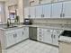 Bright kitchen featuring white cabinetry, granite countertops and modern stainless steel appliances at 2736 Darby Falls Dr, Las Vegas, NV 89134