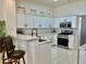 Open kitchen with stainless steel appliances, granite countertops, and breakfast bar seating at 2736 Darby Falls Dr, Las Vegas, NV 89134