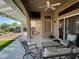 Inviting covered patio features comfortable seating, ceiling fan, and access to the backyard at 2736 Darby Falls Dr, Las Vegas, NV 89134