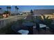 Inviting patio with seating and fire pit offers a stunning view of the city skyline at night at 2736 Darby Falls Dr, Las Vegas, NV 89134